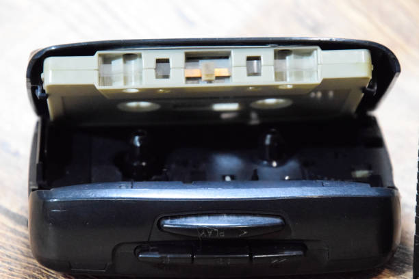 istock Retro audio cassettes next to a portable player to play compact cassettes. 1370960098