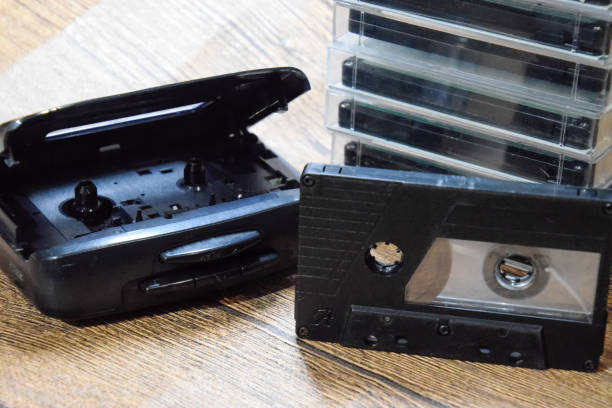 istock Retro audio cassettes next to a portable player to play compact cassettes. 1370960101