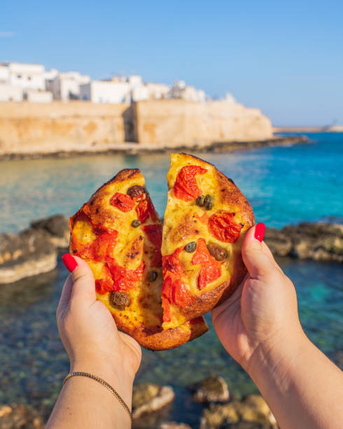 View of Monopoli The costal town of Monopoli and Apulian focaccia monopoli puglia stock pictures, royalty-free photos & images