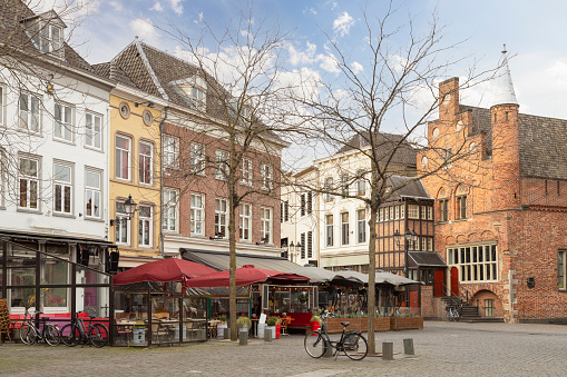 Old houses and cozy restaurants on the market square in the center of Den Bosch in the Netherlands.