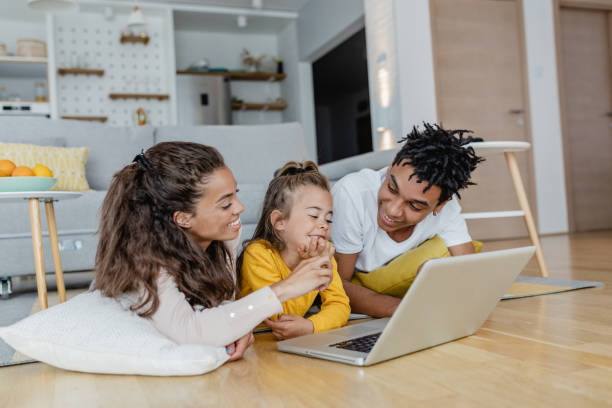 istock Young happy family using laptop at home 1370967425