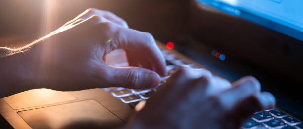 istock Girl is working on a laptop at night, hands closeup. 1370971766