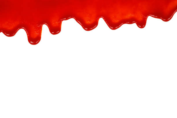 Red ketchup dripping on white background stock photo