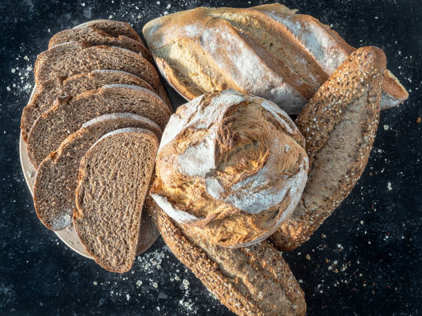 istock Fresh rolls, whole wheat bread and bread cut and floured. 1370972946