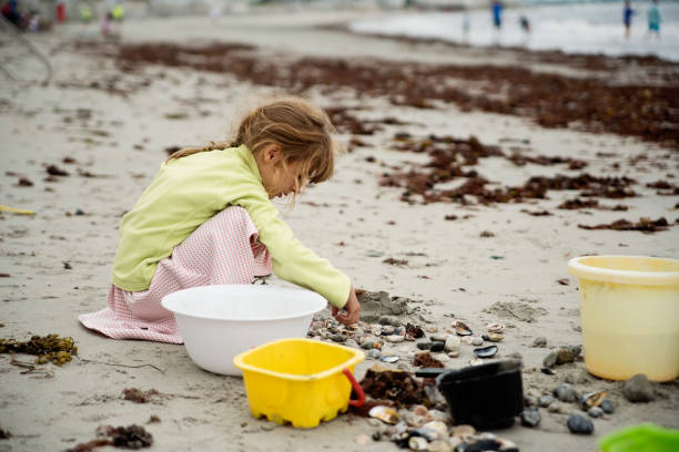 Child playing on tropical beach. Little girl at sea shore. Family summer vacation. Kids play with water and sand toys. Ocean and island fun. Travel with young children. Asia holiday.