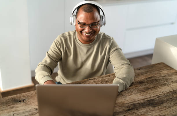 istock Happy senior man smart working using laptop at home - Technology concept 1370978209