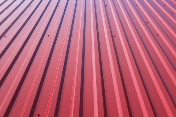 Red sheeting on the roof. Close-up. Vertical view. Background. Texture. stock photo