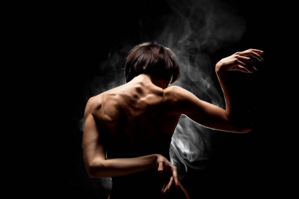 istock half silhouette modern ballet dancer posing on dark background with smoke 1370979090