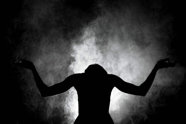 istock silhouette modern ballet dancer posing on dark background with smoke 1370979109
