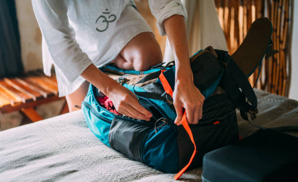 istock Woman trying to close her backpack 1370985466