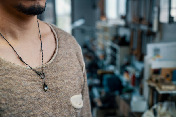 istock Silver necklace on a millennial aged man 1370989717