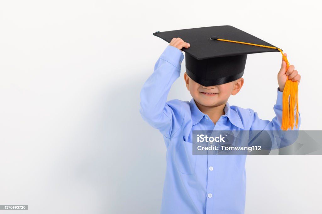 Happy Kid boy in graduation cap and cover eyes Childhood Stock Photo