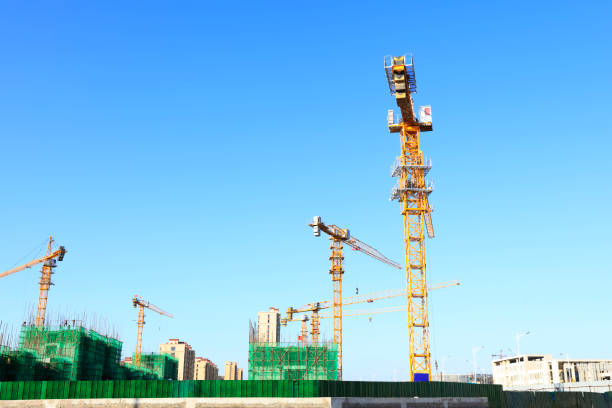istock the construction worker's tower crane, Residential buildings are under construction 1370993741