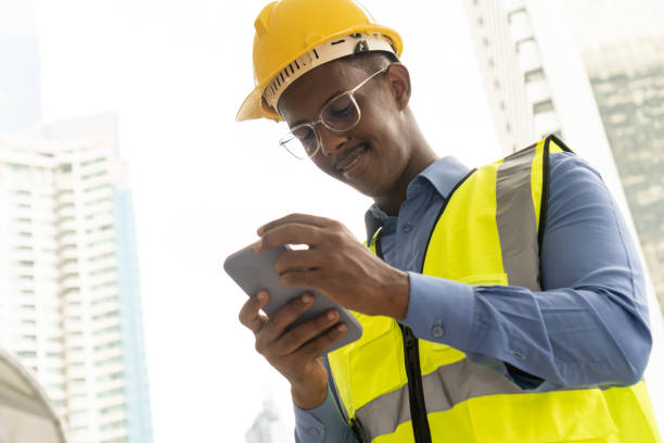 istock Worker Wearing Safety Vest and Hard Hat. 1370995419