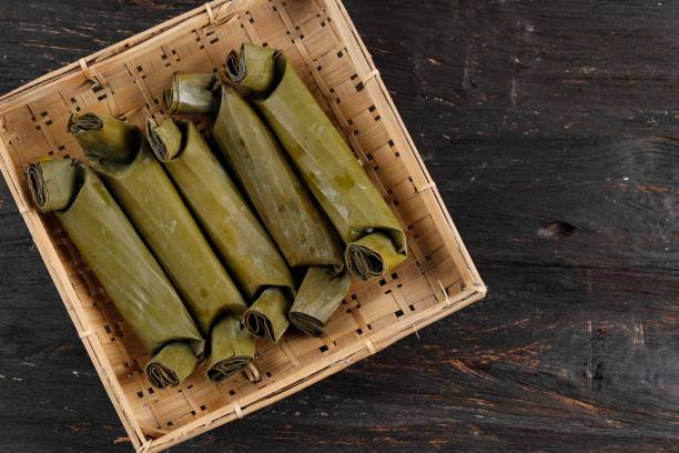 istock Lontong, Indonesian Compressed Rice Cake with Cylinder Shape, Wrapped with Banana Leaf 1370998026