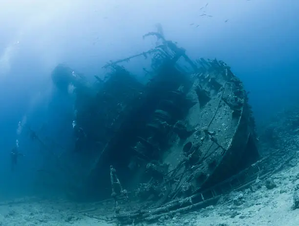 Scuba divers exploring the Red Sea shipwreck the  Giannis D, Abu-Nuhas, Red Sea, Egypt. Taken July 2010