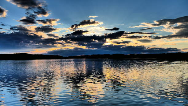 istock Metallic-looking sunset over the river with clouds 1370999086