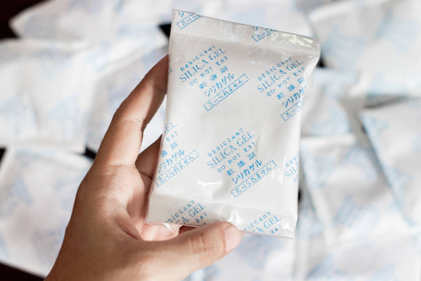 istock Desiccant gel bag on hand with Silica backgrounds 1371005342