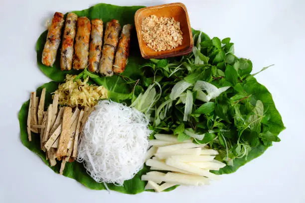 Top view Vietnamese homemade vegan food, fried spring rolls with bun herbal leaf and rice paper, healthy dish for lunch with non meat eating