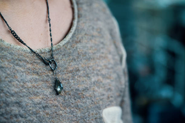 istock Silver necklace on a millennial aged man 1371007438