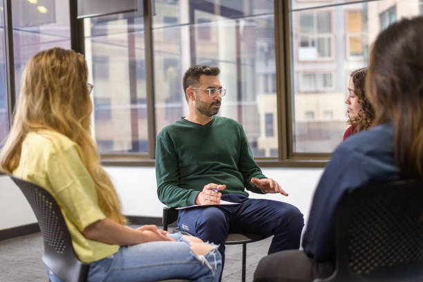 istock Young adult man sharing life experience in group therapy 1371011132