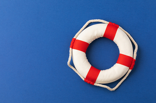 Lifebuoy on a blue background with copy space, top view