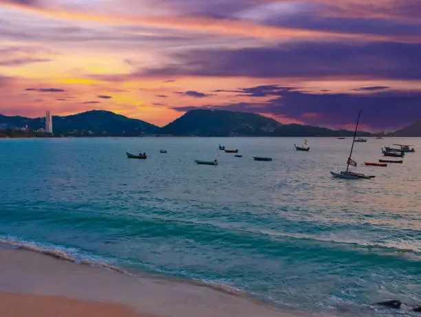 Long tail Boat on colourful sunset over Patong Beach Phuket Thailand