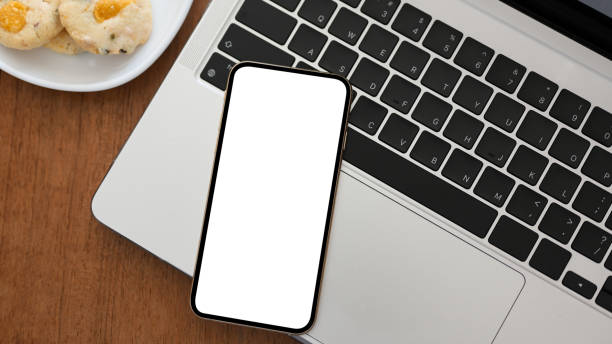 istock A smartphone white screen mockup on laptop keyboard 1371024137