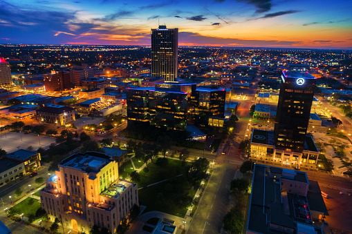 Downtown Amarillo skyline aerial view with a beautiful sunset in the background, the Firstbank Southwest Tower in the upper center, and Potter County Courthouse in the lower left.