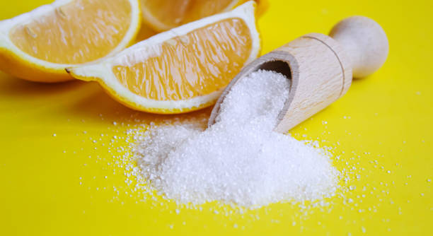 istock Citric acid on a yellow background. Selective focus. 1371028590