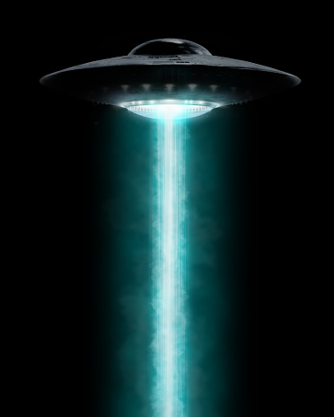 UFO hovering with a light beam coming down, isolated on black