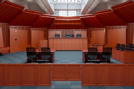 Empty Courtroom With Empty Chairs, Wooden Desks And Jury Box