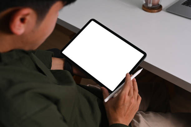 istock Close up view young businessman using digital tablet at comfortable workplace. 1371030814