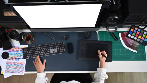 istock Overhead view female graphic designer working with computer and graphic tablet. 1371031681