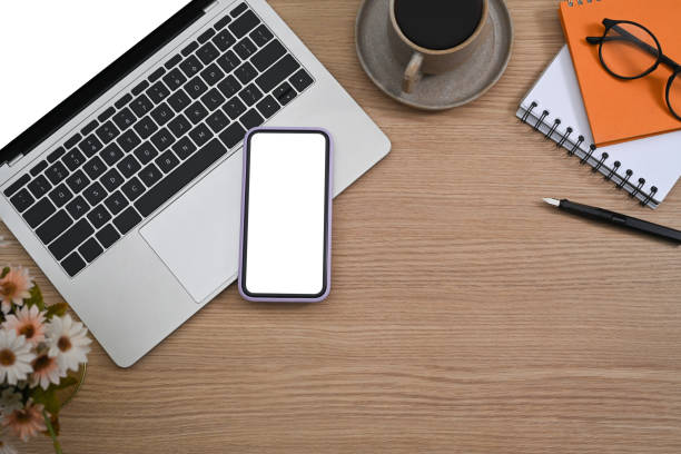 istock Smart phone, laptop computer, coffee cup and notebook on wooden background. 1371031805