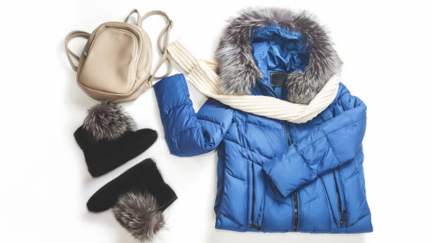 istock Warm jacket with a backpack, scarf and boots on a white background. Women's stylish autumn or winter clothes. Cozy winter look. Flat lay, top view. 1371036188
