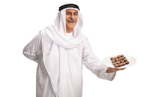 istock Mature arab man holding a plate with falafel and smiling 1371037635