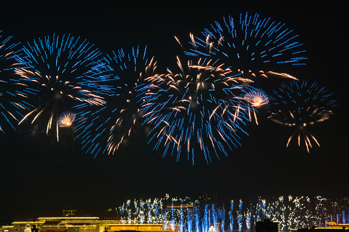 Fireworks with silhouettes of people in a holiday events.New Year fireworks on the beach. Travelers and people celebrate New year day at Kamala Beach Phuket, Thailand.