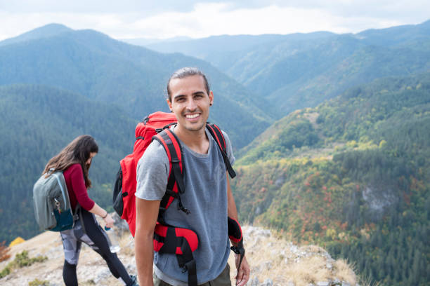 istock Smiling man on a hike with friends. 1371039077