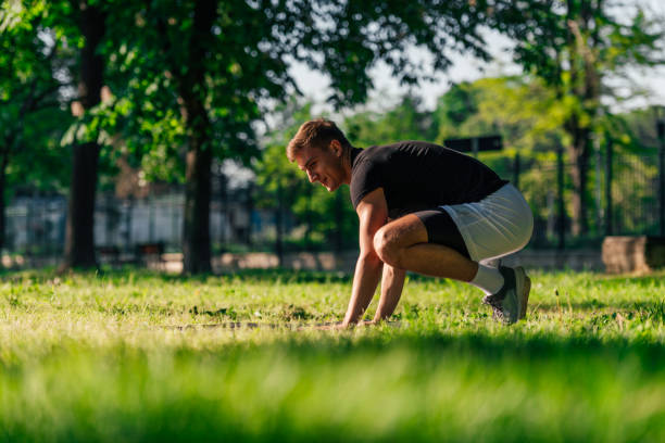istock Sporty young man practicing crow pose or yoga asana, outdoors in a park 1371042829