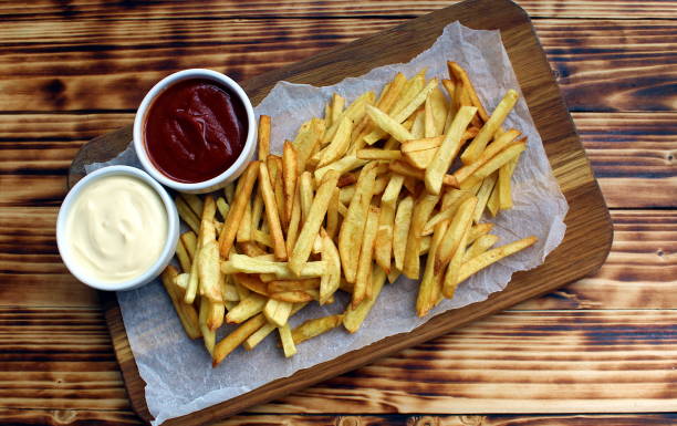 istock French fries on a cutting board with a cone 1371042884
