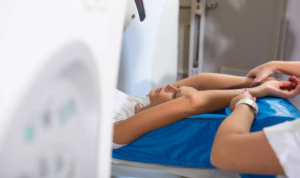 istock Pretty, young woman going through a Computerized Axial Tomography (CAT) Scan medical test/examination in a modern hospital 1371045204