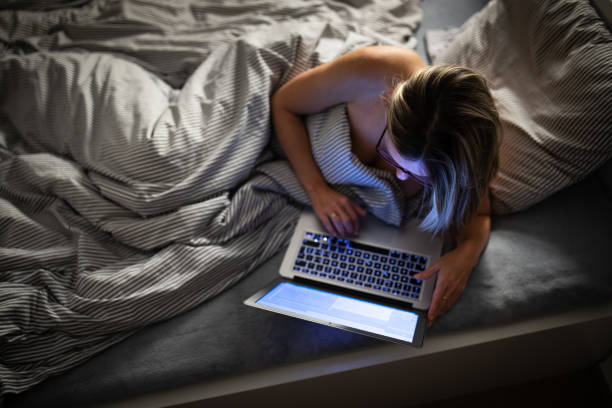 istock Pretty, middle-aged woman using her laptop computer before sleep 1371045919