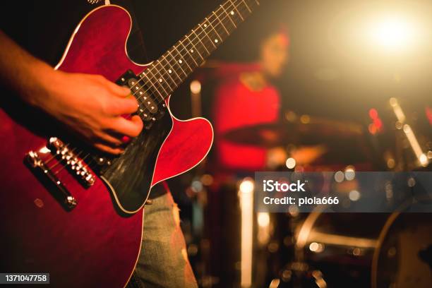 Indie Rock Guitarist Playing Guitar In A Live Show With Stage Lights Stock Photo - Download Image Now