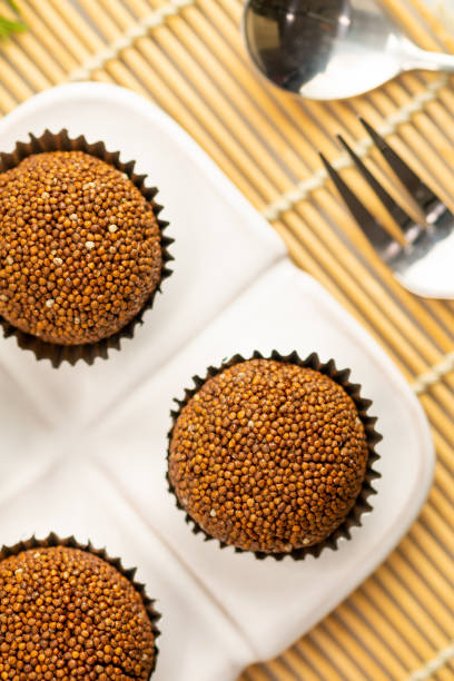istock Perilla seed mixed with Jaggery palm sugar and mold into a ball place on a white plate decorated with mint leaves on a bamboo mat with spoons and forks. 1371049277