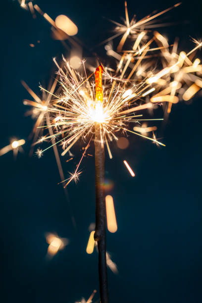 istock Christmas bengal fire sparkles against the black background. 1371049537