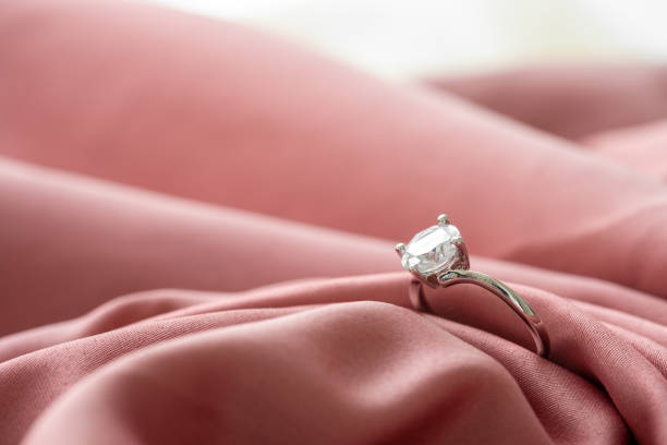 istock The wedding diamond ring is placed on a pink gold cloth. 1371049610