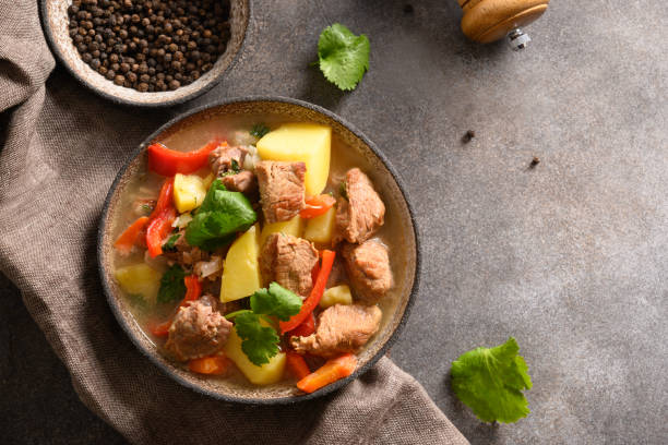 istock Beef stew with vegetables, potatoes, pepper on brown background. 1371050396