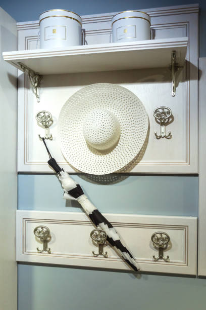 istock Straw women's hat and umbrella hanging on a hanger 1371051097