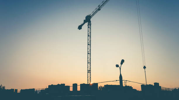 istock Silhouette of construction crane on the sunset background. 1371051547
